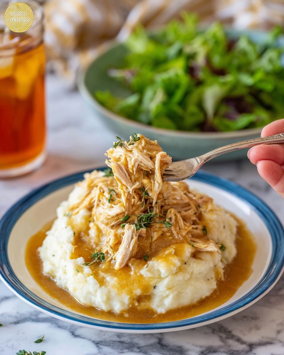 The image shows a close-up of shredded chicken mixed with a thick, creamy orange sauce inside a black slow cooker. The chicken is tender and fibrous, coated well in the smooth sauce that fills the base of the slow cooker. A blue spoon with white speckles lifts a generous scoop of the saucy chicken, showing the rich texture and vibrant orange color clearly. The background is soft and out of focus, emphasizing the warm, hearty dish. Photo taken with an iphone --ar 4:5 --v 7