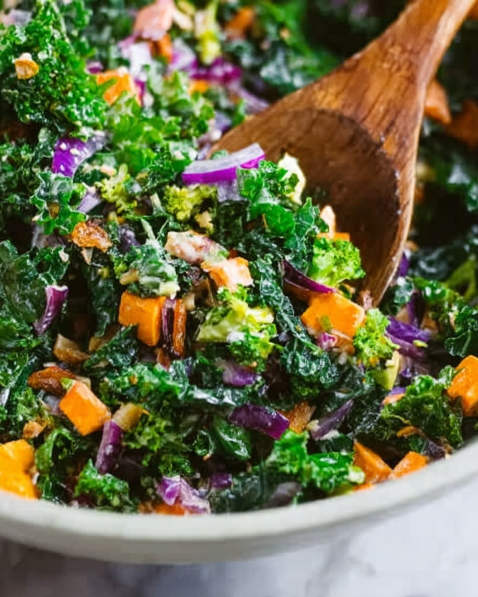 The image shows a bowl full of fresh salad with many colorful layers. The bottom layer includes dark green kale leaves with a curly texture. On top of that, there are small bright green broccoli pieces spread evenly. Thin strips of orange carrot are scattered throughout, adding a bright contrast. There are also small cubes of yellow cheese and pieces of light purple onion mixed in. Tiny sunflower seeds and some dark dried fruits are sprinkled on top. The bowl is white and sits on a white marbled surface. photo taken with an iphone --ar 4:5 --v 7