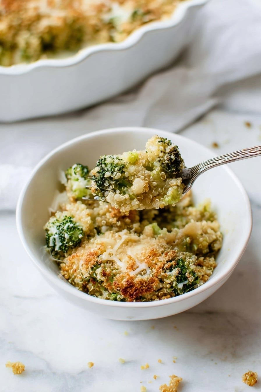A close-up view shows a white bowl with a textured rim filled with a broccoli quinoa casserole. The dish has several layers visible: bright green broccoli pieces mixed with light tan quinoa, topped with a crumbly golden-brown crust sprinkled with some melted white cheese strands. The casserole looks baked, with some crispy bits giving it a crunchy texture. A silver fork stands inside the bowl on the right side, partially covered in the casserole. The bowl sits on a soft white cloth over a white marbled surface. Photo taken with an iphone --ar 2:3 --v 7 - Better Broccoli Casserole, broccoli casserole recipe, cheesy broccoli bake, healthy broccoli casserole, easy vegetable casserole