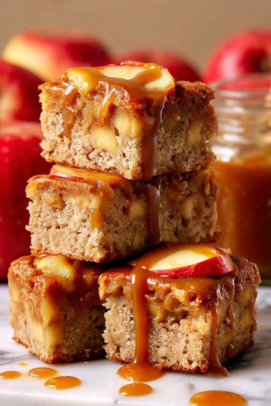 The image shows four thick square pieces of apple cake stacked on each other on a white marbled surface. Each piece has a light brown, porous texture with visible chunks of apple inside and apple slices on top. The top layer is covered in a shiny, caramel brown sauce that drips down the sides of the cake pieces. In the background, there are red apples and a glass jar filled with caramel sauce, slightly blurred. The lighting highlights the moist texture of the cake and the glossy caramel sauce photo taken with an iphone --ar 2:3 --v 7 - Caramel Apple Cake, apple cake with caramel, fall apple dessert, moist apple cake recipe, easy apple cake with caramel drizzle