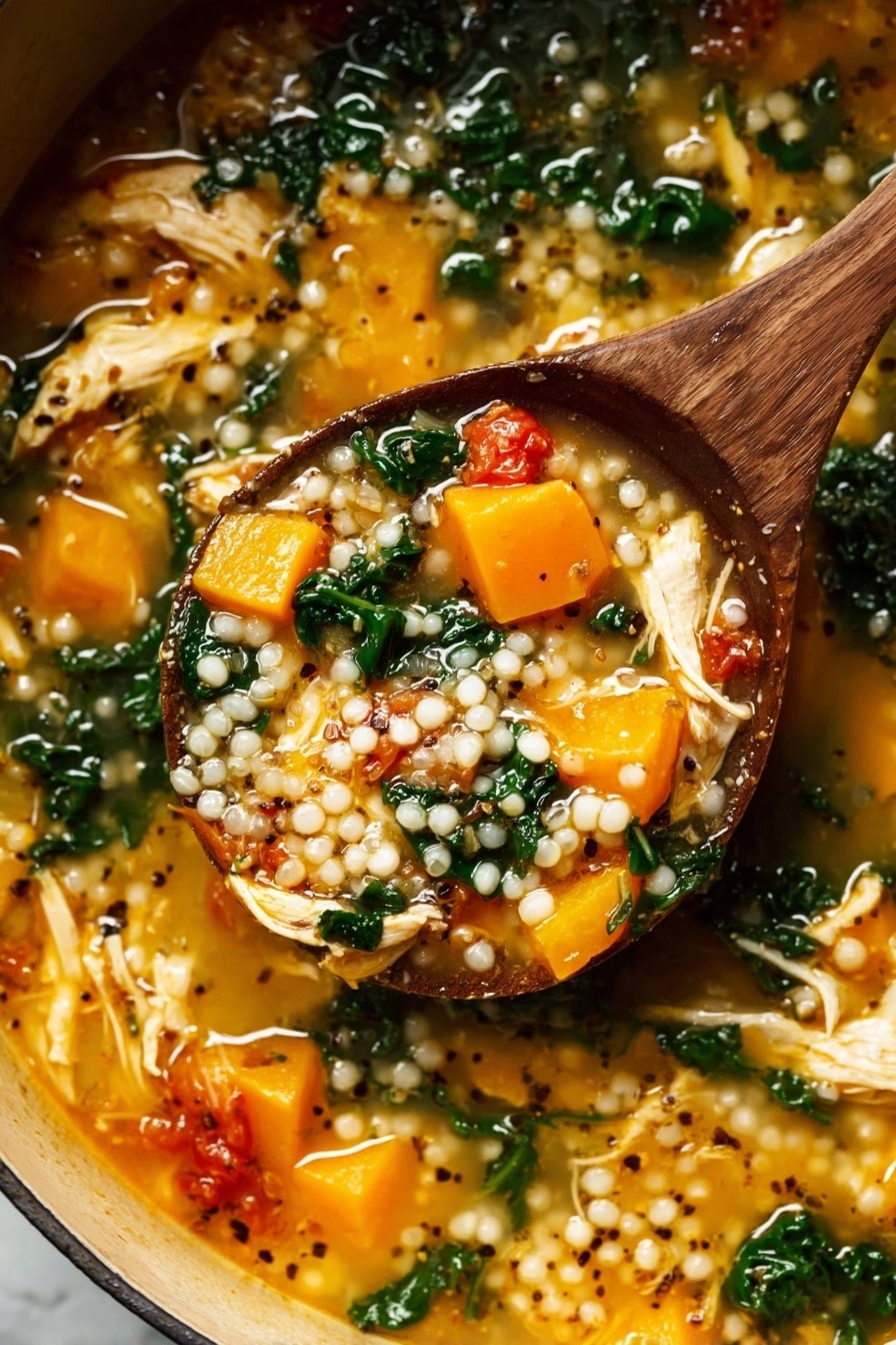 A wooden spoon lifts a thick soup filled with three main layers: plump white pearl-like grains scattered throughout, soft bright orange chunks of cooked squash, and wilted dark green leafy vegetables mixed in a light golden broth. The soup also contains pieces of shredded pale yellow chicken and small red tomato chunks, with black and white mustard seeds floating on top, all inside a pot sitting on a white marbled surface. The texture looks rich and hearty with a mix of soft and tender ingredients. Photo taken with an iphone --ar 2:3 --v 7 - Fall Chicken Stew with Quinoa and Butternut Squash, hearty fall chicken stew, healthy chicken stew recipes, nourishing winter stew, cozy autumn meal ideas