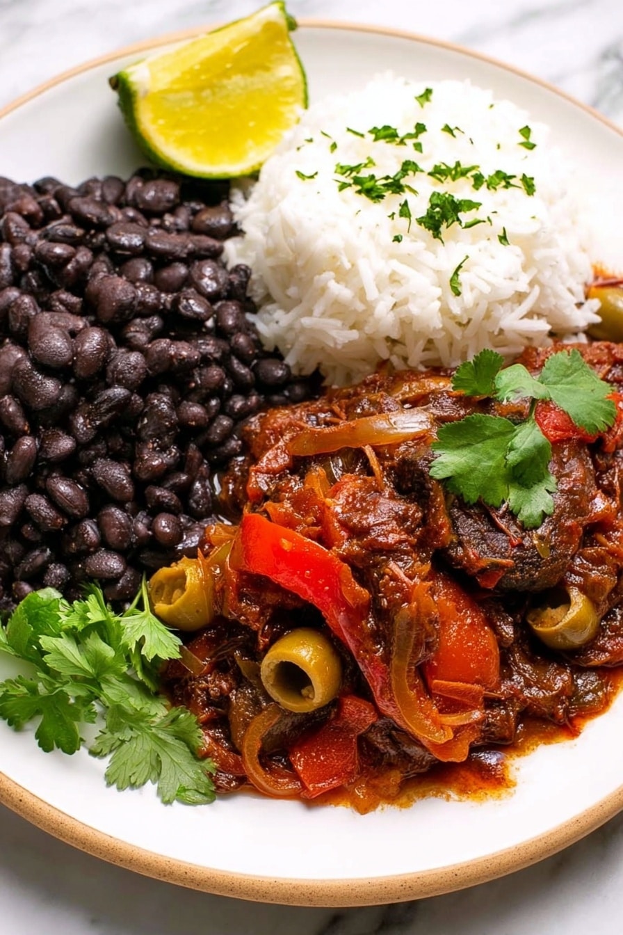 A white plate holds three main layers of food on a white marbled surface. On the left side is a thick layer of black beans with a slightly soft texture made from many whole beans. Next to the beans, on the right side of the plate, is a mound of fluffy white rice with a light, grainy texture. In the front and center, there is a layer of rich, dark red stew with visible pieces of green olives and slices of red bell pepper, covered in a thick, sauce with a chunky texture. A bright yellow lemon wedge rests on the left side of the plate, and a small sprig of fresh green cilantro is placed on top of the stew, adding a touch of vibrant color. Photo taken with an iphone --ar 2:3 --v 7 - Slow Cooker Ropa Vieja, Cuban shredded beef stew, Cuban beef recipes, easy Cuban dinner, slow cooker beef stew