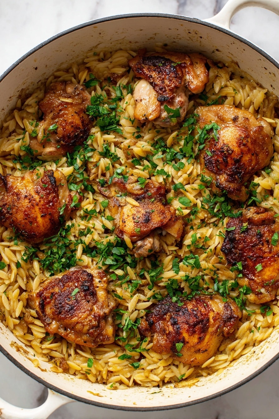 A white pot filled with light golden orzo pasta as the base layer, topped with five crispy browned chicken thighs spread evenly across the pasta. The chicken has a slightly shiny texture from cooking, with a mix of golden and darker brown spots. Bright green chopped herbs are sprinkled generously on top, adding a fresh contrast to the warm tones of the chicken and pasta. The pot sits on a white marbled surface. Photo taken with an iphone --ar 2:3 --v 7 - One Pot Garlic Butter Chicken and Orzo, garlic butter chicken recipe, easy one pot chicken dinner, creamy chicken and orzo, quick weeknight chicken meal