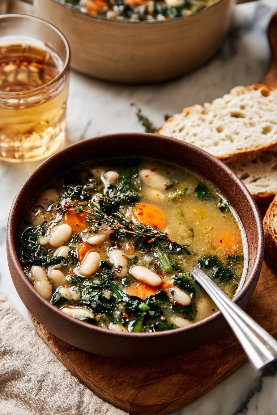 A bowl of soup with light golden broth fills the bowl, showing two layers of ingredients: the first layer has white beans and bright orange carrot slices, while the second layer includes dark green leafy herbs and some small herbs sprinkled on top. The bowl is brown and sits on a wooden board with pieces of white bread beside it. A shiny silver spoon rests inside the bowl. Behind the bowl, a clear glass of light brown drink and a large beige pot can be seen, all placed on a white marbled surface with a beige cloth underneath. Photo taken with an iphone --ar 2:3 --v 7 - Tuscan White Bean Soup, hearty Italian soup, easy white bean soup, vegetarian Italian soup, comforting bean soup
