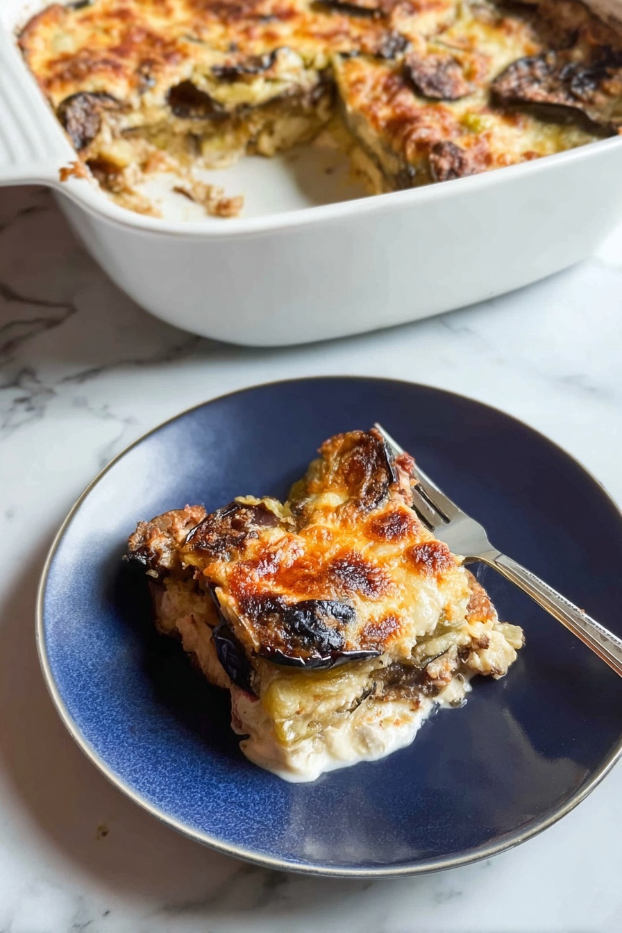 A white casserole dish sits in the background, filled with a baked layered dish that has a golden, slightly browned cheese crust with some darker browned spots, showing eggplant or similar vegetables beneath. In the foreground, a piece of this dish is served on a white plate, showing three visible layers: the top layer is melted golden cheese with some browned spots, the middle layer has slices of dark brown roasted eggplant, and the bottom layer is a white creamy base, possibly cheese or sauce. A fork rests on the plate next to the food. The background surface is a white marbled texture. Photo taken with an iphone --ar 2:3 --v 7 - Chicken Zucchini Bake with Mozzarella, healthy chicken zucchini casserole, cheesy zucchini bake, low-carb chicken zucchini dish, protein-packed zucchini bake