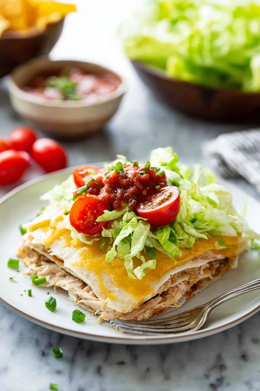 A white plate holds a layered dish with four clear layers: the first layer is a soft tortilla in light beige, topped with shredded cooked chicken in light brown; the second layer is another tortilla; the third is melted golden-yellow cheese with a creamy texture; the fourth layer consists of fresh bright green lettuce, bright red halved cherry tomatoes, green sliced chives, and a small spoonful of chunky red salsa on top. A silver fork lies on the plate's edge. The background shows a white marbled surface with out-of-focus bowls of salsa, chips, and lettuce. Photo taken with an iphone --ar 2:3 --v 7 - Easy Chicken Quesadilla Casserole, chicken quesadilla casserole, cheesy chicken bake, quick dinner recipes, family-friendly casseroles
