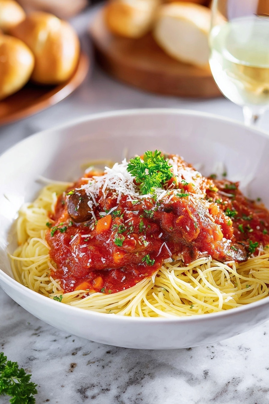 A white bowl filled with a bed of yellow spaghetti noodles forms the bottom layer, topped with red tomato sauce mixed with dark brown mushroom pieces and a piece of cooked white meat covered in sauce at the center. White shredded cheese is sprinkled lightly over the sauce and meat, and a small green parsley sprig sits on top for garnish. A golden brown breadstick lies diagonally on the left edge of the bowl. The bowl is placed on a white marbled surface with a metal fork resting inside the bowl on the right side, partially under the sauce. Photo taken with an iphone --ar 2:3 --v 7 - Slow Cooker Chicken Cacciatore, Italian chicken slow cooker, Easy chicken cacciatore recipe, Crockpot chicken dinner, flavorful Italian chicken