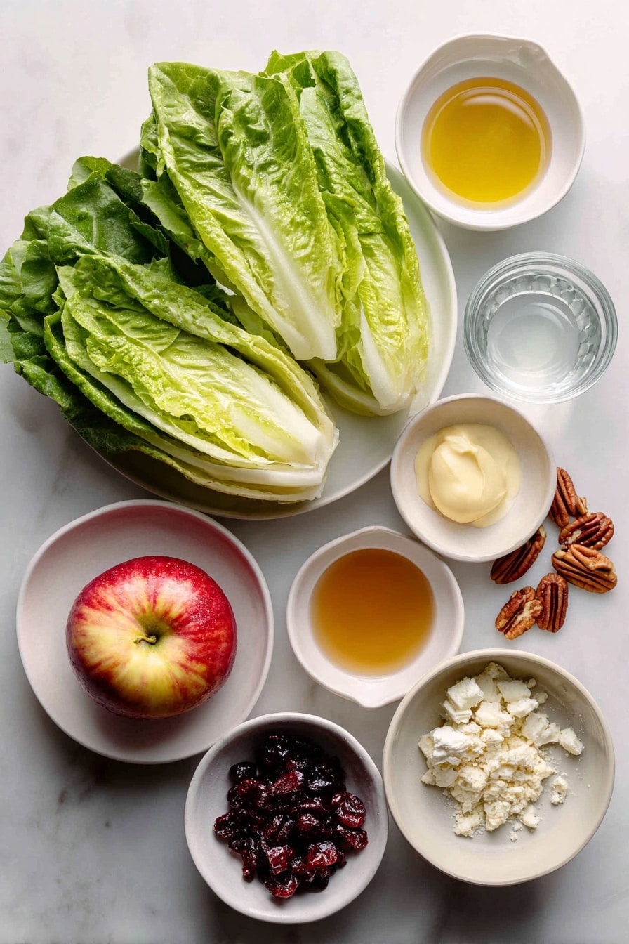 Flat lay of a fresh whole head of crisp romaine lettuce with vibrant green leaves, a bright red and yellow Honeycrisp apple sliced to reveal its juicy interior, a small white ceramic bowl filled with golden canola oil, a small white bowl containing amber apple cider vinegar, a small white bowl holding clear water, a small white bowl with smooth pale yellow Dijon mustard, a small white bowl of granulated white sugar, a neat pile of reddish-brown cooked bacon pieces, a small mound of dried dark red cranberries, creamy white crumbled bleu cheese, and a small cluster of glossy brown pecan halves, all arranged symmetrically on a simple white ceramic plate and bowls placed on a clean white marble surface, soft natural light, photo taken with an iPhone, professional food photography style, fresh ingredients, white ceramic bowls, no bottles, no duplicates, no utensils, no packaging --ar 2:3 --v 7 --p awthu7i m7354615311229779997 - Honeycrisp Harvest Salad, fall salad with apples, apple and bacon salad, Autumn fruit salad, easy apple salad recipe