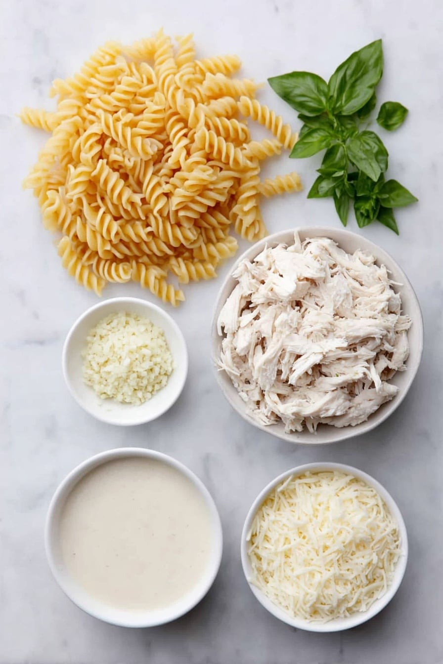 Flat lay of uncooked rotini pasta in a small heap, a few pieces of shredded rotisserie chicken piled neatly, a small white bowl filled with creamy Alfredo sauce, a small white bowl holding chicken stock, a small white bowl with finely minced garlic, a small white bowl heaped with shredded mozzarella cheese, a small white bowl containing grated Parmesan cheese, and a few sprigs of fresh basil, oregano, and parsley arranged symmetrically, all placed on a clean white marble surface, soft natural light, photo taken with an iPhone, professional food photography style, fresh ingredients, white ceramic bowls, no bottles, no duplicates, no utensils, no packaging --ar 2:3 --v 7 --p awthu7i m7354615311229779997 - Easy Chicken Alfredo Bake, chicken Alfredo bake, creamy chicken pasta bake, cheesy baked chicken Alfredo, quick comfort dinner