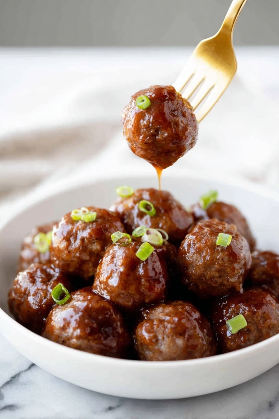 A white bowl filled with about a dozen shiny, brown meatballs covered in a thick, glossy sauce. The meatballs have a smooth, sticky texture and are garnished with small pieces of green onion scattered on top. One meatball is held above the bowl by a gold fork, with sauce dripping down from it. The scene is set on a white marbled surface. Photo taken with an iphone --ar 2:3 --v 7 - Sticky Honey Garlic Meatballs, Honey Garlic Meatballs, Easy Meatball Recipes, Quick Dinner Ideas, Sweet and Savory Meatballs