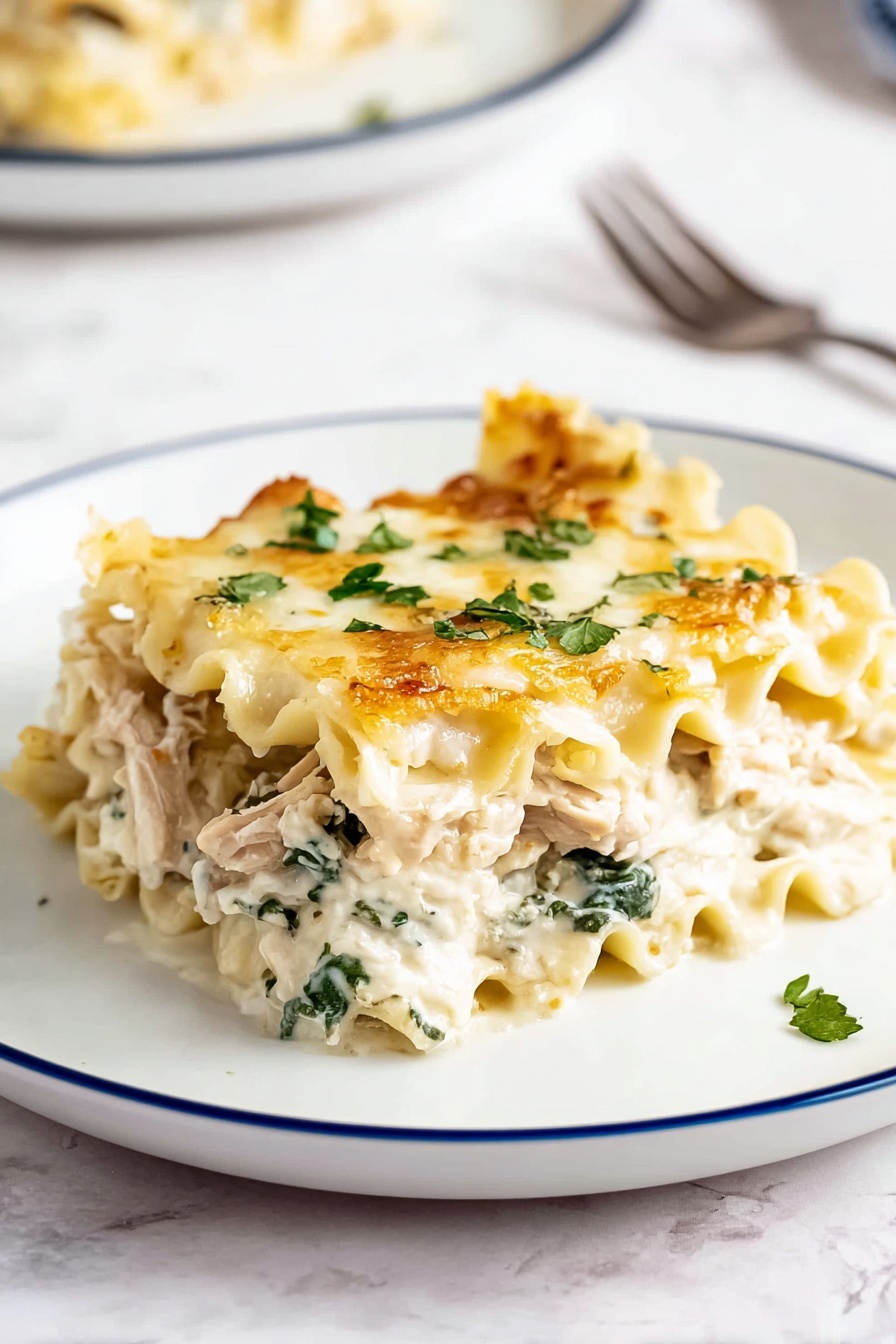 A single piece of lasagna is placed on a white plate with a thin blue rim, showing about four layers. The top layer is light golden with melted cheese and small green parsley flakes scattered on it. Below that is a creamy white sauce mixed with green spinach leaves and chunks of light brown cooked chicken. The pasta layers are soft and wavy, pale yellow in color, separating the cheesy and vegetable layers. The plate is on a white marbled surface with a blurred second plate and a fork in the background. Photo taken with an iphone --ar 2:3 --v 7 - Creamy Chicken Boursin Alfredo Lasagna, Chicken Boursin Alfredo Lasagna, Creamy Chicken Lasagna with Boursin, Boursin Chicken Alfredo Pasta, Easy Chicken Boursin Lasagna