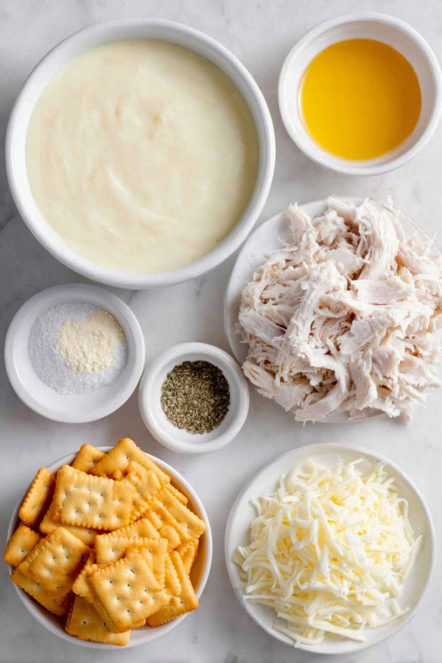 Flat lay of two white ceramic bowls—one filled with thick creamy condensed cream of chicken soup, the other holding smooth sour cream; a small white bowl with fine pale onion powder, another small white bowl with powdery garlic powder; a small white bowl containing coarse kosher salt next to a small white bowl with ground black pepper; a heaping pile of shredded cooked chicken arranged neatly; a mound of shredded sharp cheddar cheese; a small white bowl holding melted golden butter; and a cluster of lightly crushed shiny golden Ritz crackers, all placed on a clean white marble surface, soft natural light, photo taken with an iPhone, professional food photography style, fresh ingredients, white ceramic bowls, no bottles, no duplicates, no utensils, no packaging --ar 2:3 --v 7 --p awthu7i m7354615311229779997 - Cheesy Chicken Casserole, easy chicken casserole, creamy chicken bake, cheesy chicken dinner, weeknight chicken recipes
