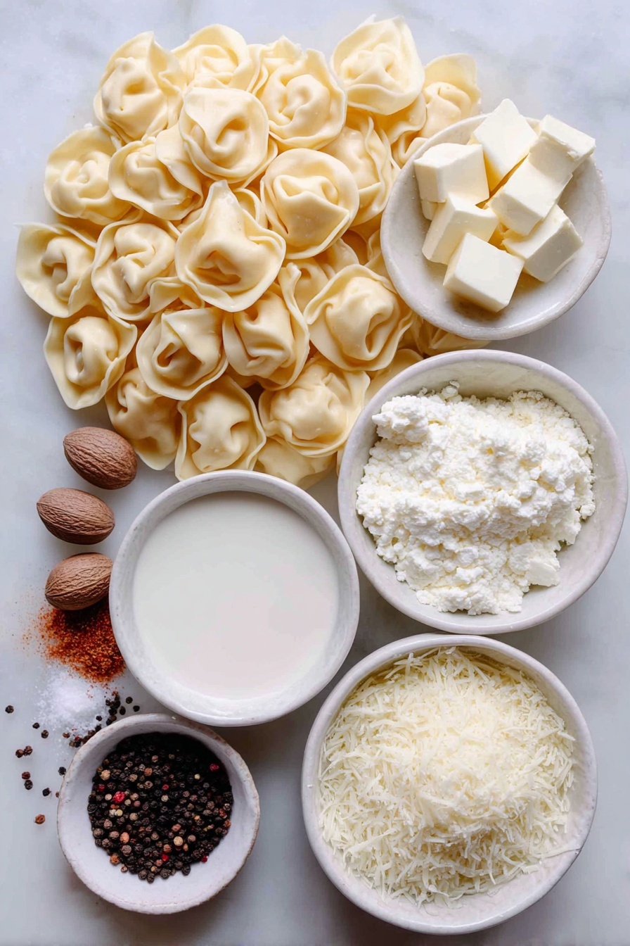 Flat lay of a mound of fresh cheese tortellini pasta, a small white ceramic bowl of unsalted butter cubes, a small white ceramic bowl filled with heavy cream, a small white ceramic bowl of freshly grated parmesan cheese, a few whole nutmeg seeds next to a small pile of ground nutmeg, a small cluster of whole black peppercorns with some freshly ground black pepper scattered nearby, all arranged symmetrically and balanced, placed on a clean white marble surface, soft natural light, photo taken with an iPhone, professional food photography style, fresh ingredients, white ceramic bowls, no bottles, no duplicates, no utensils, no packaging --ar 2:3 --v 7 --p m7354615311229779997 - Creamy Cheese Tortellini, cheesy tortellini pasta, quick tortellini dinner, easy cheese tortellini recipe, indulgent pasta dishes