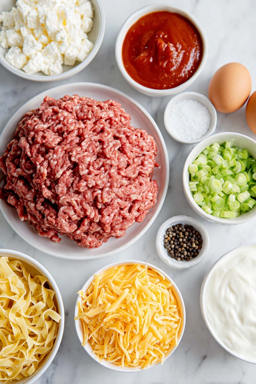 Flat lay of fresh raw ground chuck shaped in a loose mound, a small white ceramic bowl of smooth red tomato sauce, a small white ceramic bowl of thick white sour cream, a small white ceramic bowl filled with small curd cottage cheese, a neat pile of uncooked golden egg noodles, a handful of vibrant green sliced green onions arranged in a small white ceramic bowl, a small white ceramic bowl heaped with shredded sharp cheddar cheese, two whole brown eggs with clean shells, a small white ceramic bowl of coarse black peppercorns, a small white ceramic bowl of white salt crystals, all placed with perfect symmetry on a clean white marble surface, soft natural light, photo taken with an iPhone, professional food photography style, fresh ingredients, white ceramic bowls, no bottles, no duplicates, no utensils, no packaging --ar 2:3 --v 7 --p m7354615311229779997 - Sour Cream Noodle Bake, Easy Ground Beef Casserole, Creamy Baked Noodles, Cozy Weeknight Dinner, Cheesy Pasta Bake
