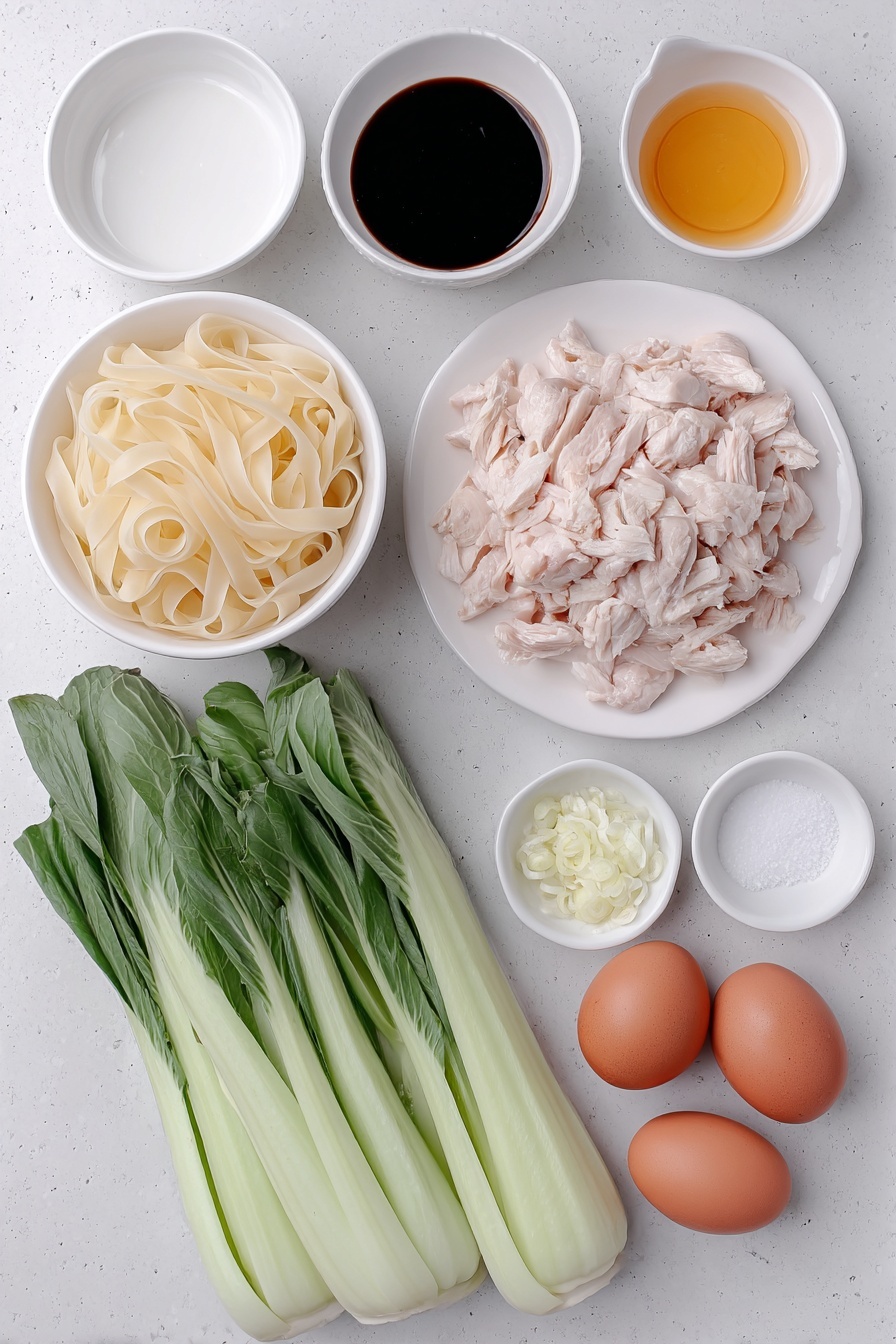 Flat lay of a small pile of fresh wide flat rice noodles (Sen Yai), two small white ceramic bowls containing dark soy sauce and oyster sauce, another small white bowl with light soy sauce, a small white bowl with white vinegar, a small white bowl with sugar crystals, three tablespoons of peanut oil in a small white bowl, two whole uncracked brown eggs, two peeled garlic cloves finely chopped and displayed in a small white bowl, a portion of raw sliced boneless skinless chicken thighs arranged neatly on a simple white ceramic plate, and four fresh Chinese broccoli stems with vibrant green leaves and crisp stalks laid out beside them, all placed on a clean white marble surface, soft natural light, photo taken with an iPhone, professional food photography style, fresh ingredients, white ceramic bowls, no bottles, no duplicates, no utensils, no packaging --ar 2:3 --v 7 --p m7354615311229779997 - Thai Pad See Ew, easy Pad See Ew recipe, authentic Thai noodles, quick Thai stir-fry, homemade Thai street food