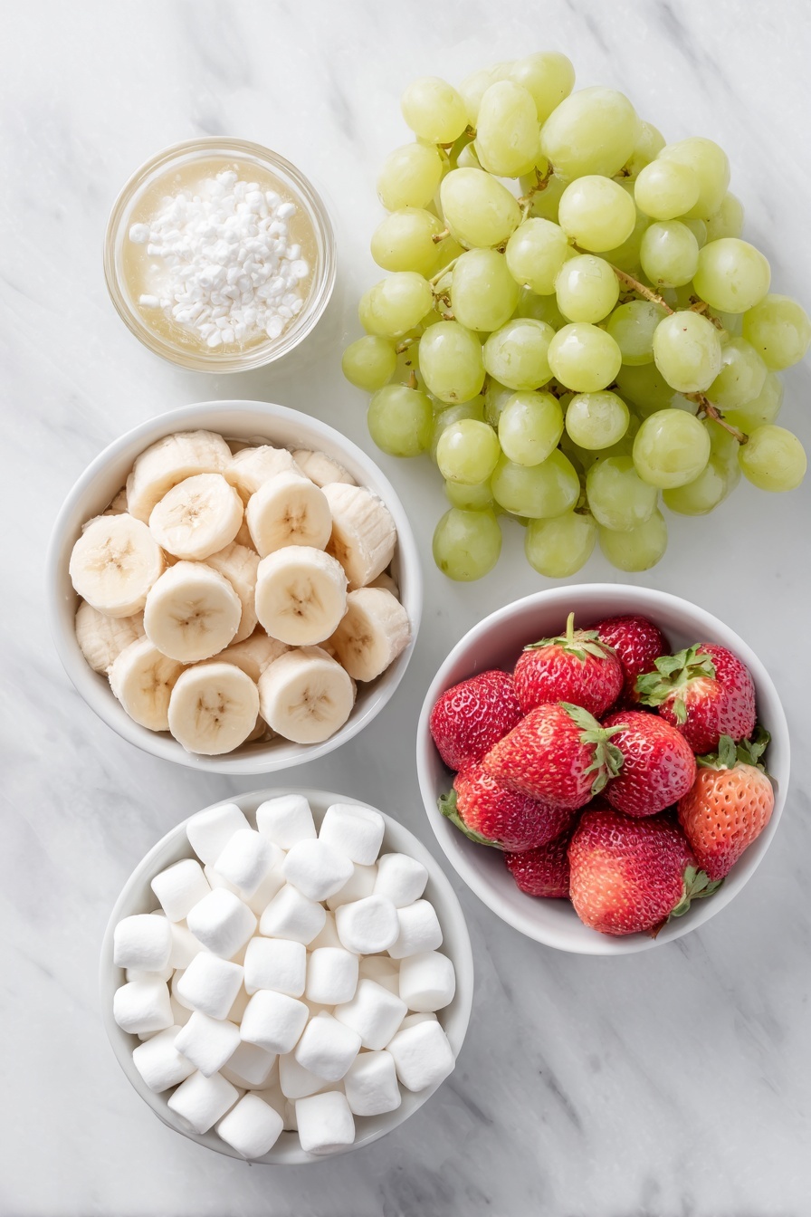 Flat lay of fresh green grapes, a large ripe banana sliced into thick rounds resting in a small white ceramic bowl with a bit of fruit juice, plump red strawberries with hull ends removed, and a small white ceramic bowl filled with white miniature marshmallows, all arranged with perfect symmetry and realistic proportions on a clean white marble surface, soft natural light, photo taken with an iPhone, professional food photography style, fresh ingredients, white ceramic bowls, no bottles, no duplicates, no utensils, no packaging --ar 2:3 --v 7 --p m7354615311229779997 - Grinch Fruit Kabobs, holiday fruit skewers, festive snack ideas, kid-friendly party treats, colorful fruit kabobs
