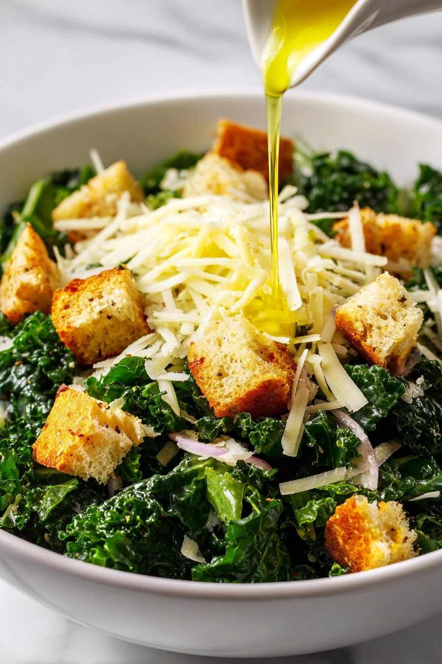 This image shows a close-up of a fresh salad in a white bowl on a white marbled surface. The salad has three main layers: at the bottom is a layer of dark green chopped kale with a textured surface, on top of that are golden-brown croutons scattered all over, and the final layer is shredded pale yellow cheese sprinkled evenly, mixed with small bits of light pink onion. A thin stream of yellow olive oil is being poured over the cheese at the center of the bowl. The photo is vibrant and detailed, focusing closely on the textures of the salad. photo taken with an iphone --ar 2:3 --v 7 - Crispy Parmesan Kale Salad, kale salad with parmesan, healthy kale salad recipes, crunchy kale salad, tangy kale salad with breadcrumbs