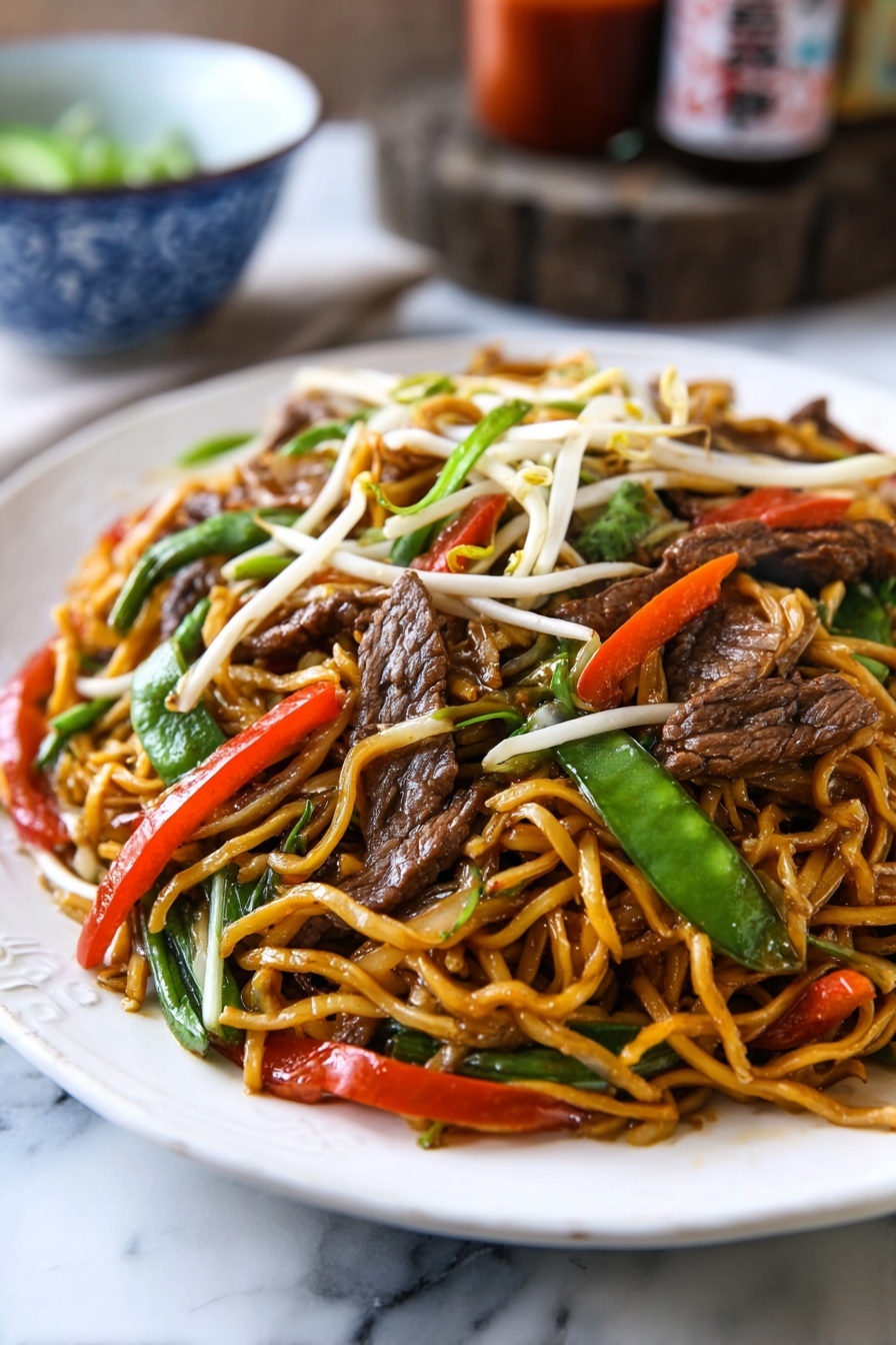 A white oval plate is filled with stir-fried noodles that are light brown and glossy, mixed with slices of dark brown beef, bright green snow peas, thin red chili strips, white bean sprouts, and pieces of translucent onion. The noodles are twisted and piled up high on the plate, with colorful vegetables and beef evenly spread throughout. The plate sits on a rustic wooden surface, with a blue cloth partially visible under one side. In the background, there are two brown bottles with red labels and a white bowl with blue patterns. photo taken with an iphone --ar 2:3 --v 7 - Beef Lo Mein Stir-Fry, beef stir-fry recipe, easy Chinese stir-fry, quick weeknight dinner, flavorful beef and vegetable stir-fry