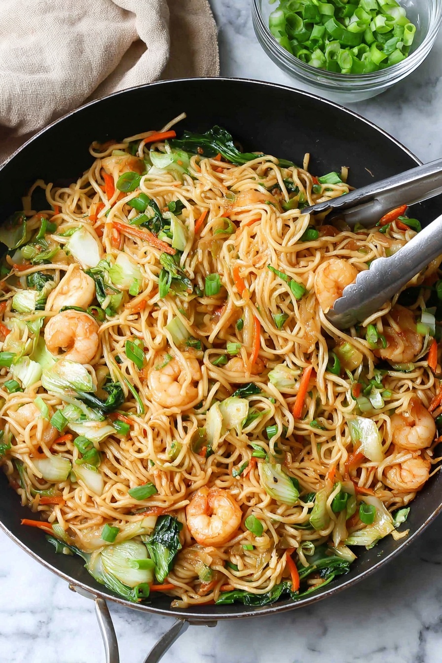 A large black pan is filled with a colorful stir-fry of noodles, shrimp, and vegetables. The base layer has light brown noodles that are thin and mixed with bright green pieces of bok choy and carrot sticks in orange. On top are pink shrimp, slightly browned with black pepper sprinkled on them, scattered throughout. Small pieces of green onions are spread over the whole dish, adding fresh green color. Chopsticks hold a small bundle of noodles and shrimp above the pan. In the background, a small clear glass bowl holds more green onions, and a light wooden pepper grinder is visible. The scene sits on a white marbled textured surface with a light gray cloth napkin beside the pan photo taken with an iphone --ar 2:3 --v 7 - Shrimp Lo Mein Stir Fry, Chinese takeout-style shrimp stir fry, easy shrimp lo mein, quick shrimp stir fry recipe, homemade shrimp lo mein