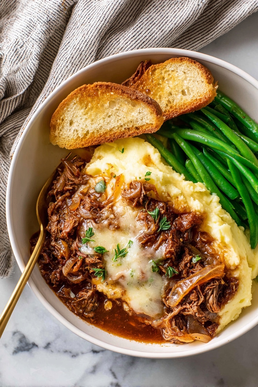 In a white bowl placed on a white marbled surface, there is a dish made of several layers: the bottom left layer is smooth, pale yellow mashed potatoes, topped with a thick layer of rich brown meat with melted white cheese and cooked onions covering the center. To the right, there are bright green cooked green beans stacked neatly. At the top left, two slices of toasted bread rest on the mashed potatoes, all under warm natural light. A golden fork is partly inserted into the mashed potatoes near the meat. A soft, striped towel is seen in the top left corner. Photo taken with an iphone --ar 2:3 --v 7 - French Onion Beef Pot Roast, French Onion Soup Inspired Dinner, Hearty Beef Roast with Caramelized Onions, Slow Cooker Beef Pot Roast, Comfort Food Recipes