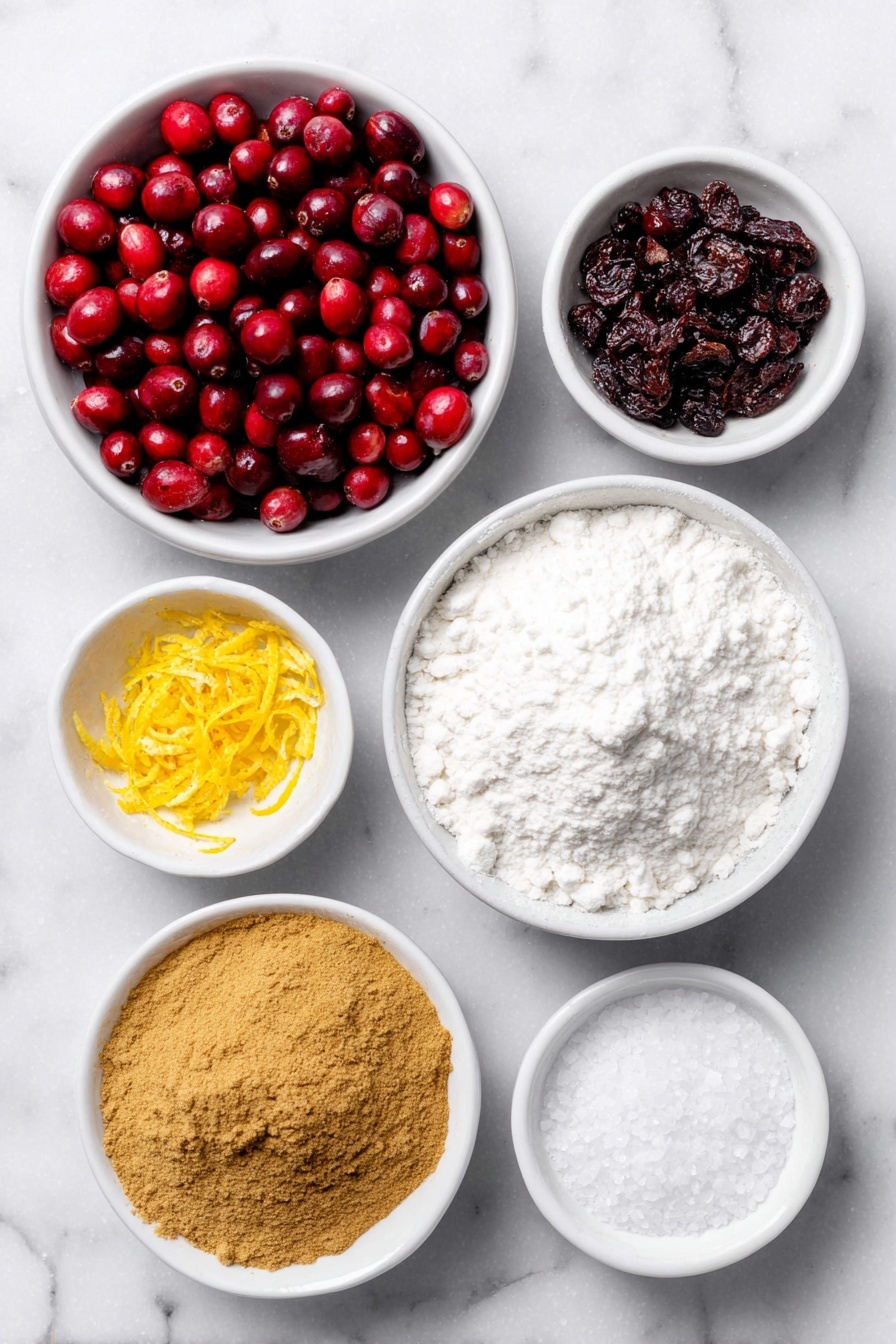Flat lay of a small mound of fresh bright red cranberries, a small white ceramic bowl filled with fine white granulated sugar, a few strips of fresh orange zest curled gently, a small white bowl of deep golden ground cinnamon powder, a small white bowl of warm brown ground ginger powder, a small white bowl of fine white cornstarch powder, a small white bowl with freshly squeezed orange juice showing a vibrant orange color, a small white bowl containing coarse kosher salt crystals placed symmetrically—all items arranged with perfect balance and fresh natural appearance, placed on a clean white marble surface, soft natural light, photo taken with an iPhone, professional food photography style, fresh ingredients, white ceramic bowls, no bottles, no duplicates, no utensils, no packaging --ar 2:3 --v 7 --p m7354615311229779997 - Best Cranberry Pie, Cranberry Pie Easy, Holiday Cranberry Pie, Tart Cranberry Pie, Cranberry Pie with Orange Zest