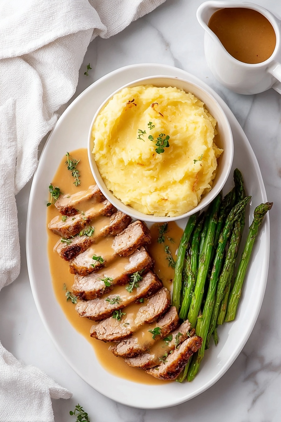 The image shows a white oval plate with three layers of food arranged neatly. On the top right, there is a white bowl filled with smooth, light yellow mashed potatoes, sitting on the plate. Below the bowl, two rows of sliced, cooked meat lay side by side, coated with a light brown sauce and garnished with small green herb leaves. On the bottom right corner of the plate, a bunch of green asparagus spears is placed parallel to the meat. The plate rests on a white marbled surface, and a white cloth is partially visible on the left side. There is also a small pitcher with brown sauce near the top right corner. Photo taken with an iphone --ar 2:3 --v 7 - Garlic Turkey Tenderloin with Easy Gravy, turkey tenderloin recipe, quick turkey dinner, flavorful turkey main dish, easy turkey gravy