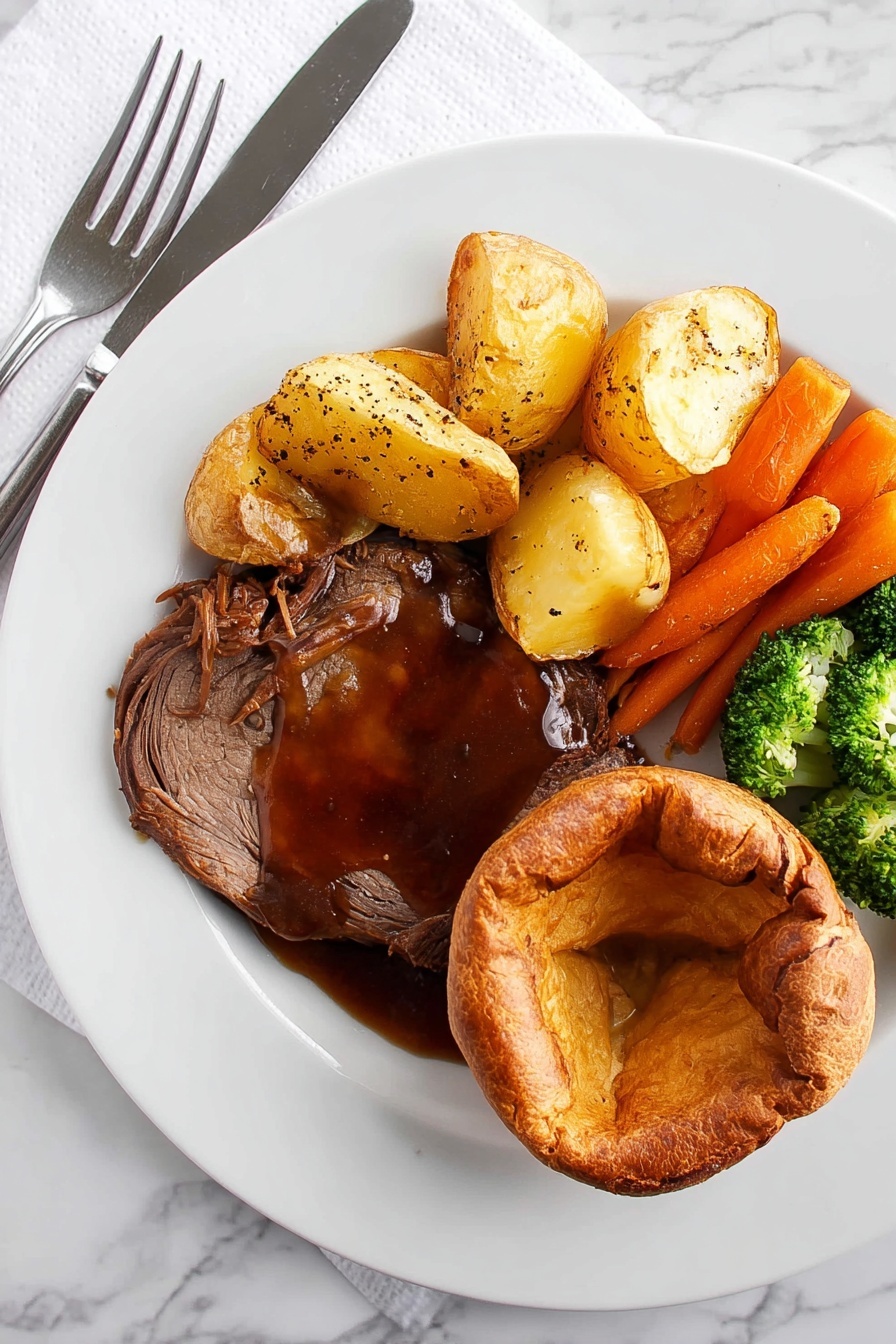 A white plate on a white marbled surface holds a meal with four parts. On the bottom right is a golden brown round Yorkshire pudding with a soft, slightly folded center. Next to it on the left is a thick slice of dark brown roast meat covered in rich, shiny brown gravy sprinkled with coarse black pepper. Above the meat are several light golden roast potatoes with a crispy surface. To the left of the potatoes is a mix of bright orange whole baby carrots and green broccoli florets with a slight shine, showing they are cooked but still fresh. A knife and fork rest on the left side of the plate on a white napkin. Photo taken with an iphone --ar 2:3 --v 7 - Yorkshire Pudding, Perfect Yorkshire Pudding, British Yorkshire Pudding, Crispy Yorkshire Pudding, Fluffy Yorkshire Pudding