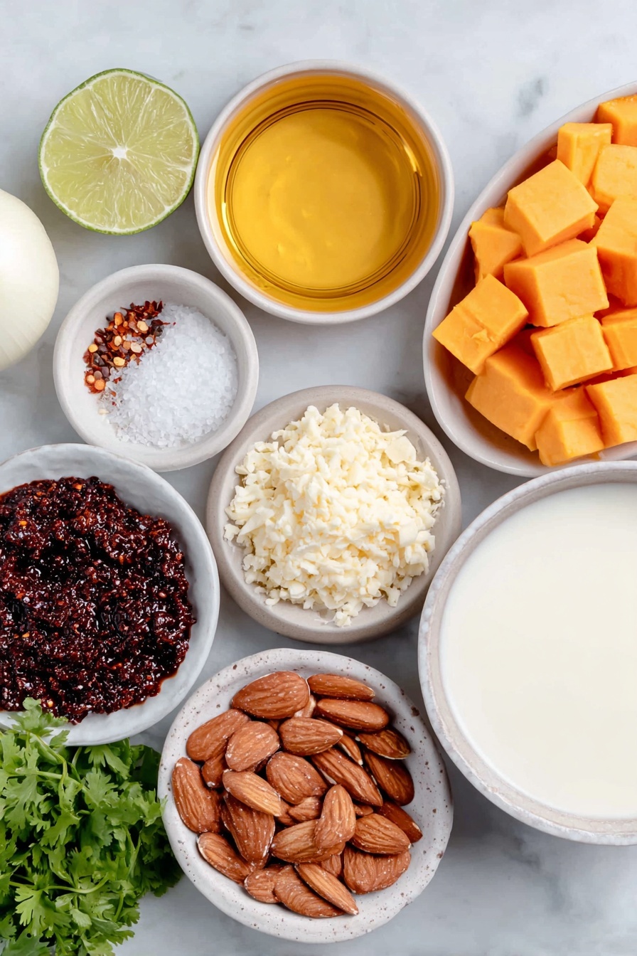 Flat lay of a small white ceramic bowl of golden oil, one whole white onion with smooth skin, a small mound of freshly minced ginger, vibrant orange cubed butternut squash, a small white ceramic bowl holding deep red curry paste, another small white bowl with creamy smooth almond butter, a simple white bowl filled with light-colored vegetable broth, a white ceramic bowl containing thick full fat coconut milk, half a fresh green lime cut open showing juicy segments, a small white bowl of coarse salt crystals, a tiny white bowl of ground black pepper, a small neat pile of roasted sliced almonds, a handful of bright green chopped cilantro, and a small white bowl holding red chili flakes, all arranged with perfect symmetry on a clean white marble surface, soft natural light, photo taken with an iPhone, professional food photography style, fresh ingredients, white ceramic bowls, no bottles, no duplicates, no utensils, no packaging --ar 2:3 --v 7 --p m7354615311229779997 - Instant Pot Thai Curried Butternut Squash Soup, Thai Butternut Squash Soup, Easy Instant Pot Squash Soup, Healthy Thai Curry Soup, Quick Fall Comfort Soup