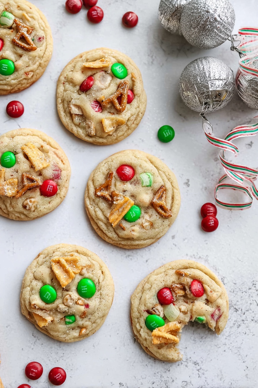 There are six round cookies arranged on a white marbled surface, each with a light golden-brown color and a soft, slightly bumpy texture. Each cookie has colorful red and green candy pieces embedded on top, along with small broken pretzel pieces and a few wavy potato chip slices. One cookie is partially eaten, showing a soft inside with candy and pretzel pieces. Around the cookies, there are scattered red and green candies, and near the top right corner, there are two large silver jingle bells with a striped ribbon. The whole scene is bright and festive, with a cozy holiday feel. photo taken with an iphone --ar 2:3 --v 7 - Santa's Trash Cookie, festive cookie recipe, holiday no-bake cookies, salty sweet cookie treats, easy Christmas cookies