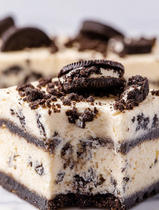 This image shows a close-up of a square dessert made of four thick layers. The base layer is creamy white with bits of dark brown cookie mixed inside. Above this is a thin, even layer of dark brown cookie pieces. The next layer is another thick creamy white layer with small cookie bits scattered throughout. The top layer is a smooth cream color studded with large crumbled pieces of dark brown cookie, some sitting on the surface. The dessert sits on a white marbled surface, and one edge shows a bite taken out. The texture looks soft and slightly firm. Photo taken with an iphone --ar 2:3 --v 7 - White Chocolate Oreo Fudge, Oreo fudge recipe, no-bake Oreo fudge, creamy white chocolate fudge, easy Oreo dessert