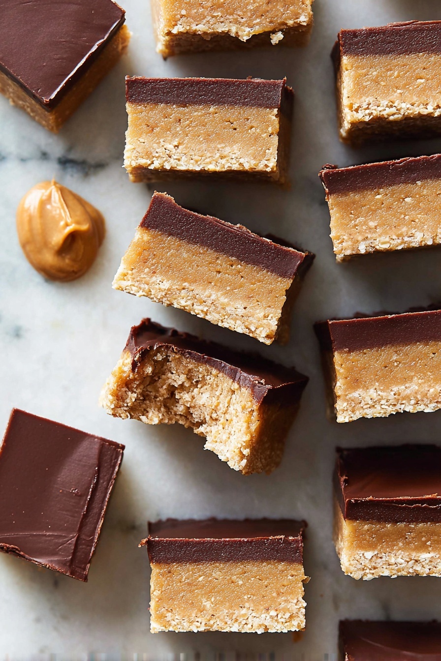The image shows multiple small square bars stacked closely together on a white marbled surface. Each bar has two clear layers: the bottom and larger layer is thick, light tan with a grainy, crumbly texture, while the top layer is thinner, smooth, and dark brown, resembling chocolate. One bar near the center has a bite taken out of it, showing more of the inside of the tan layer. There is a small dollop of smooth tan spread in the upper left corner on the marble surface. The colors contrast well with the white marbled background, and the bars have clean sharp edges. Photo taken with an iphone --ar 2:3 --v 7 - No-Bake Chocolate Peanut Butter Bars, easy chocolate peanut butter bars, no oven dessert recipes, quick peanut butter bars, homemade chocolate peanut butter bars