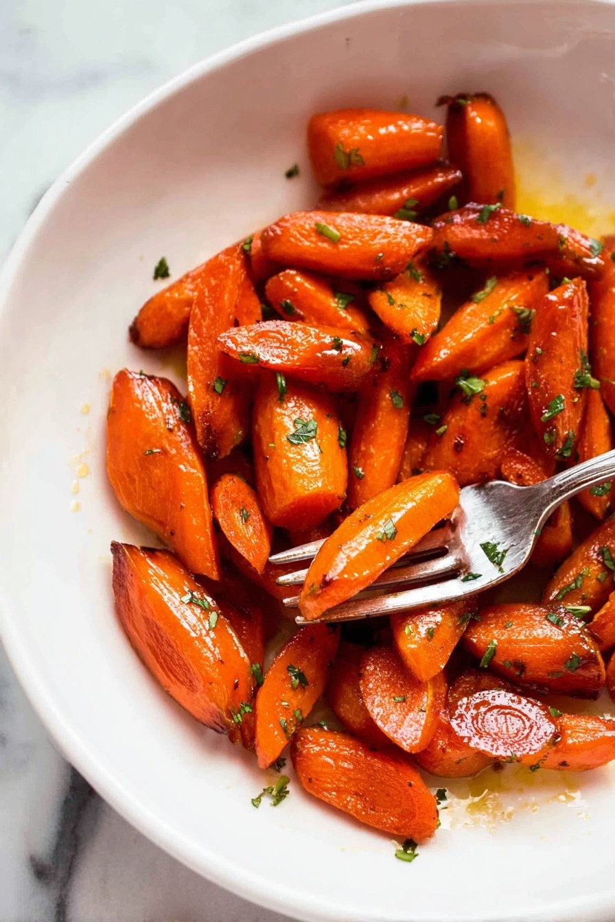 The image shows a white plate with a pile of roasted carrot pieces that are cut into small segments of different shapes, mostly oblong and triangular. The carrots are shiny with a glaze making them look moist and caramelized, with some darker browned spots on the edges indicating roasting. Small bits of green herbs are scattered over the carrots, adding a fresh contrast to the bright orange color. On the right side of the plate, a silver fork holds a piece of carrot above the surface. The background is a white marbled texture. photo taken with an iphone --ar 2:3 --v 7 - Brown Sugar Roasted Carrots, roasted carrot side dish, caramelized carrots, easy vegetable recipes, sweet roasted carrots