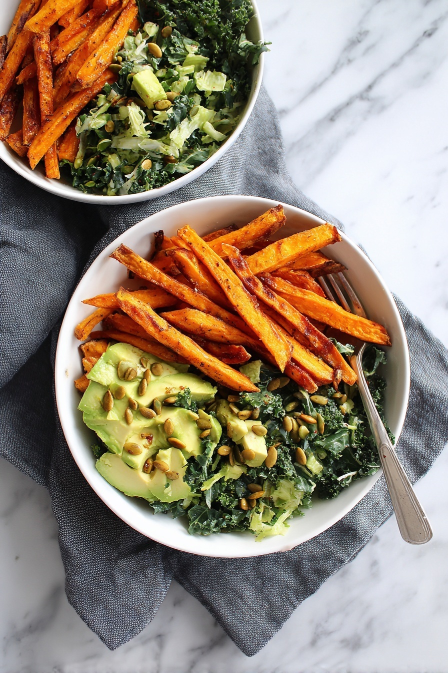 Two white bowls sit on a white marbled surface with a gray cloth nearby. Inside each bowl, two layers are visible: on one side, golden-orange sweet potato fries with a slightly crispy and charred look; on the other side, a fresh green salad made of shredded kale mixed with chunks of light green avocado and sprinkled on top with toasted pumpkin seeds giving a crunchy texture. The colors contrast well, with the deep orange fries against the vibrant green salad. A silver fork is placed close to the front bowl. Photo taken with an iphone --ar 2:3 --v 7 - Avocado Kale Caesar Salad, healthy kale salad with avocado, easy avocado kale salad, nutrient-rich Caesar salad, quick kale salad recipes
