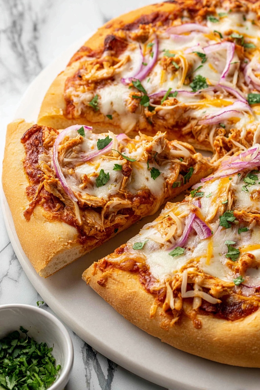 A close-up view of a pizza with a thick, golden brown crust. It has one base layer of reddish tomato sauce spread evenly, topped with a melted white cheese layer that looks soft and stretchy. On top, there are thin slices of purple onion, small pieces of light brown chicken, shredded yellow cheese, and scattered green herb bits. One slice is slightly pulled away from the rest, showing the fluffy inside of the crust. The pizza sits on a white plate placed on a white marbled surface, with a small bowl of green herbs nearby. photo taken with an iphone --ar 2:3 --v 7 - BBQ Chicken Pizza with Smoked Gouda, BBQ Chicken Pizza, Smoked Gouda Pizza, Easy BBQ Chicken Pizza, Gourmet BBQ Pizza