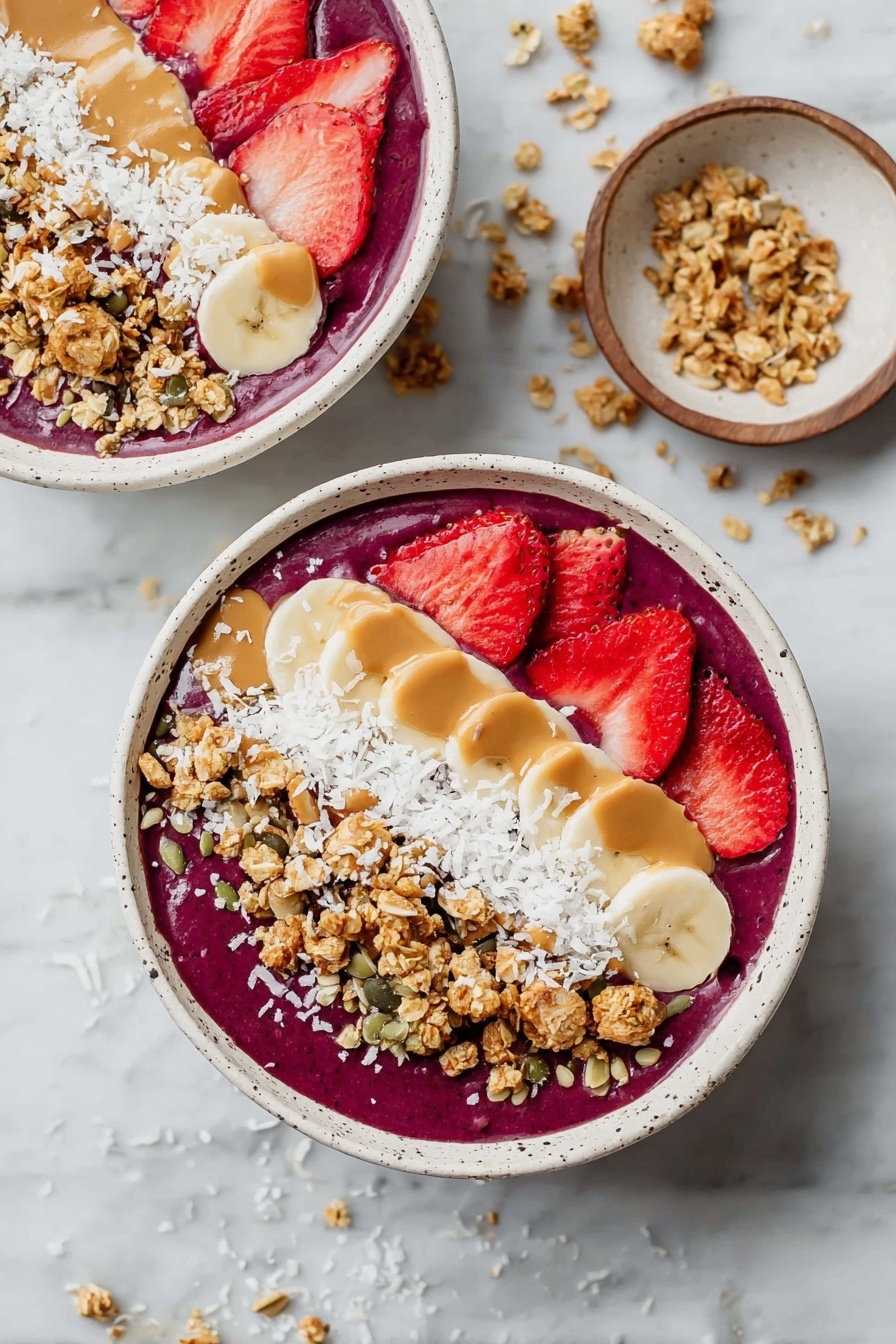 A white bowl filled with a thick purple smoothie base covers the bottom layer. On top, there are slices of bright red strawberries on the left side and creamy yellow banana slices in the middle. Crunchy golden brown granola is sprinkled across the top. There are also white coconut flakes spread over the center and edges. A creamy drizzle of light brown peanut butter is placed in the middle. A woman's hand holds a silver spoon containing banana slices, granola, and purple smoothie, lifted just above the bowl. The bowl sits on a white marbled surface with a small white bowl blurred in the background. photo taken with an iphone --ar 2:3 --v 7 - Healthy Açaí Bowl, nutritious smoothie bowl, quick breakfast recipe, healthy fruit bowl, energizing acai bowl