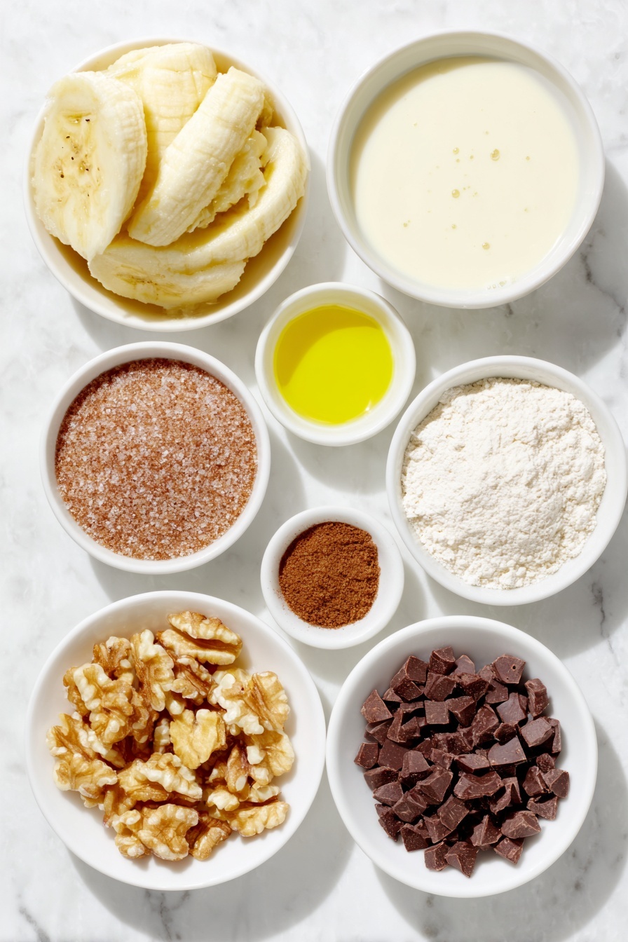 Flat lay of a peeled ripe banana mashed into a small mound, a small white ceramic bowl of golden vegetable oil, a small white ceramic bowl filled with creamy almond milk, a small white ceramic bowl of raw brown sugar crystals, a small white ceramic bowl of pale all-purpose flour, a tiny pile of fine sea salt crystals, a small mound of ground cinnamon powder, a small white ceramic bowl of baking powder, and a small white ceramic bowl containing chopped walnuts and dark chocolate chips, arranged symmetrically and balanced, all fresh and natural, placed on a clean white marble surface, soft natural light, photo taken with an iPhone, professional food photography style, fresh ingredients, white ceramic bowls, no bottles, no duplicates, no utensils, no packaging --ar 2:3 --v 7 --p m7354615311229779997 - Vegan Banana Mug Cake, healthy vegan mug cake, quick banana mug cake, plant-based microwave cake, easy vegan dessert