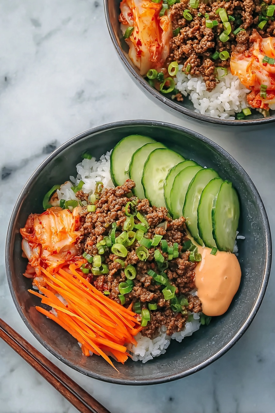 The image shows two bowls of food, each with a base layer of white rice topped with four distinct sections: a portion of brown cooked ground meat mixed with green chopped scallions, thin orange carrot strips arranged neatly, fresh cucumber slices, and a small amount of light orange sauce beside a serving of lightly reddish kimchi. The bowls are dark gray and placed on a white marbled surface with a pair of wooden chopsticks next to one bowl. The photo taken with an iphone --ar 2:3 --v 7 - Korean Beef Rice Bowls Gochujang Mayo, Korean Beef Rice Bowl recipe, spicy beef rice bowl, Korean-inspired dinner, quick weeknight meals