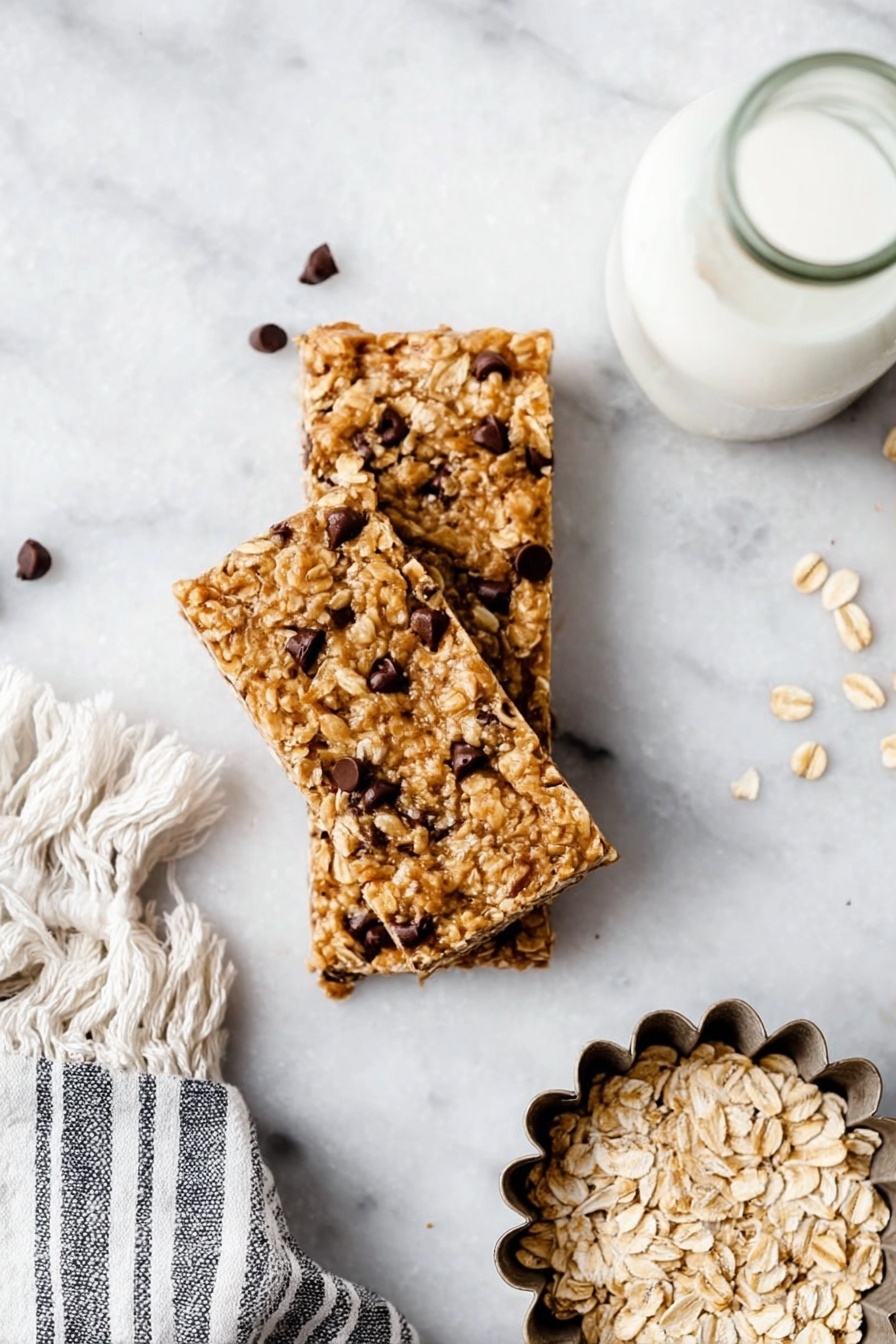 Three oatmeal chocolate chip bars are stacked in the center on a white marbled surface, showing a rough texture with visible oats and small dark chocolate chips scattered throughout each chewy tan bar. To the right side is a metal flower-shaped mold filled with plain oats, and above it is a bottle filled with white liquid, likely milk, placed near a gray and white striped towel with fringe. Photo taken with an iphone --ar 2:3 --v 7 - Homemade Peanut Butter Granola Bars, healthy peanut butter granola bar, easy DIY granola bars, nutritious snack bars, homemade energy bars