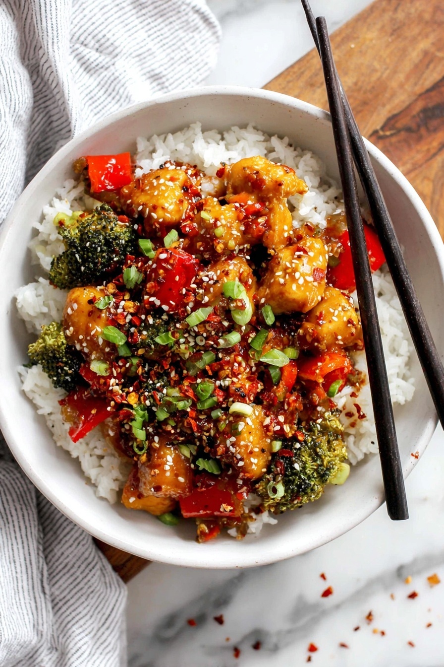 A bowl filled with white rice forms the base layer, fluffy and soft. On top, there is a vibrant mix of small broccoli florets and bright red bell pepper pieces, adding green and red color. Over the vegetables, there are chunks of golden brown chicken coated in a shiny dark sauce, making them look juicy and tasty. The dish is sprinkled with white sesame seeds, red chili flakes, and chopped green onions that add texture and a pop of green. Black chopsticks rest on the edge of the bowl, which sits on a white marbled surface next to a striped white cloth. photo taken with an iphone --ar 2:3 --v 7 - Healthy Teriyaki Chicken Bowl, delicious healthy dinner, quick chicken recipes, wholesome chicken bowl, easy stir-fry meals