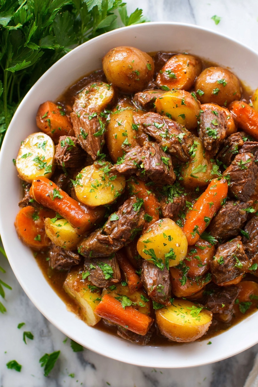 A white bowl filled with a hearty stew made of layers of chunky pieces of tender brown meat, round golden-yellow potatoes cut into halves, and thick orange carrot pieces. The ingredients are coated in a glossy brown sauce, and small green parsley leaves are sprinkled on top and around the dish for color. The bowl sits on a white marbled surface, with a bunch of fresh parsley placed beside it, partially visible in the corner. The scene is well-lit and the textures of the meat, vegetables, and sauce are clear and inviting photo taken with an iphone --ar 2:3 --v 7 - Slow Cooker Pot Roast with Vegetables, hearty beef stew, easy slow cooker dinner, comfort food recipes, tender beef and vegetables