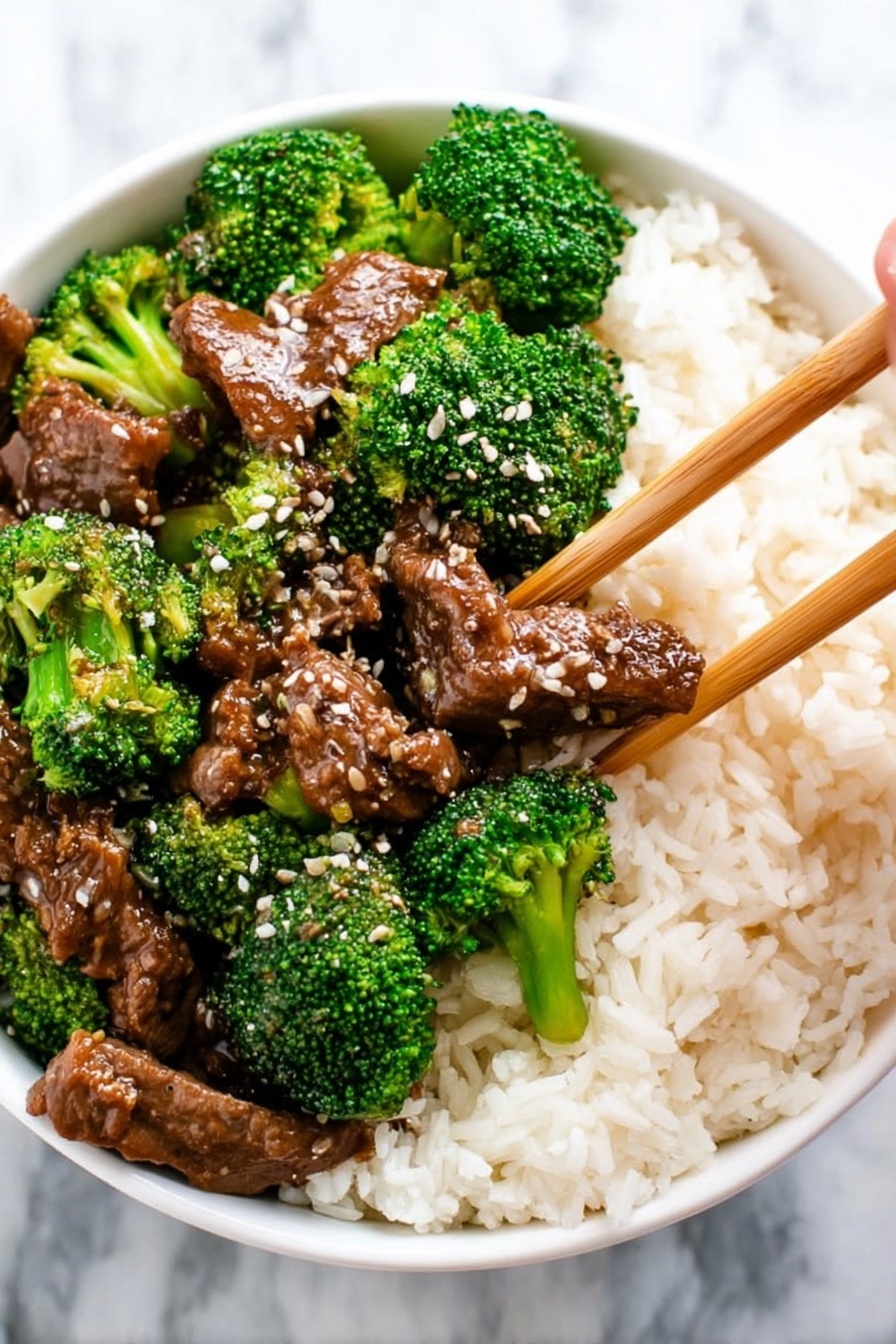 A close-up view of a dark pan filled with a rich, thick brown sauce that covers tender shredded pieces of beef and bright green broccoli florets scattered evenly throughout. In the center, a wooden spoon lifts a portion showing a mix of juicy brown beef slices and vivid green broccoli, glistening slightly under the light. The textures show the softness of the meat contrasting with the firm, fresh broccoli. The background is a white marbled texture. photo taken with an iphone --ar 2:3 --v 7 - Crockpot Beef and Broccoli Stir Fry, easy crockpot beef stir fry, slow cooker broccoli beef, healthy slow cooker dinner, homemade beef stir fry