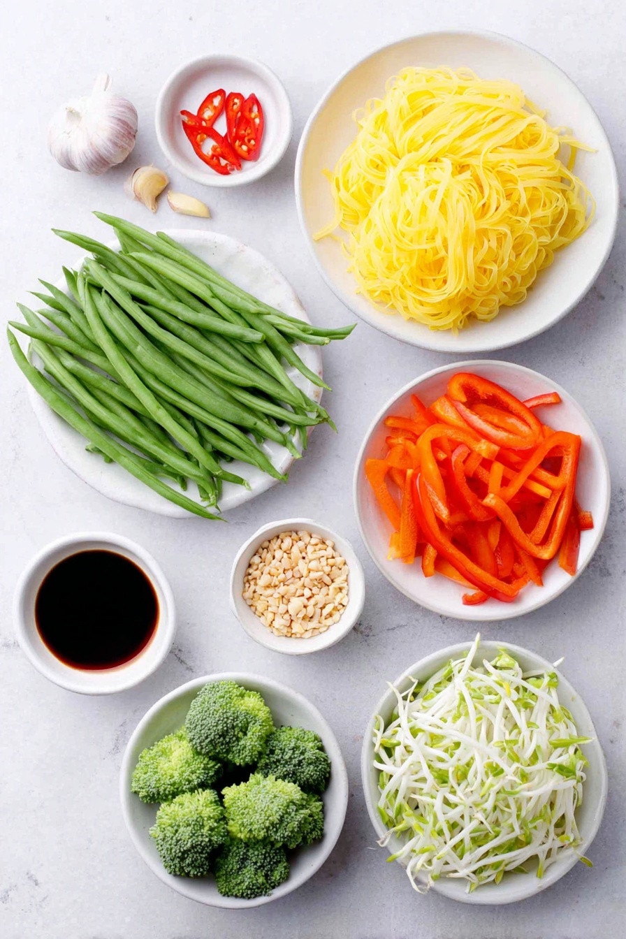 Flat lay of a small pile of wide rice noodles, two whole brown garlic cloves, a few slender green spring onions sliced on a white ceramic plate, one whole red hot chilli sliced thinly on a small white ceramic bowl, two medium orange carrots shaved into thin ribbons arranged neatly on a white ceramic dish, a large handful of bright green beans cut diagonally placed in a white bowl, half a small broccoli cut into fresh green florets on another white plate, one red bell pepper finely sliced and fanned out on a white ceramic dish, a small mound of crushed roasted unsalted peanuts on a white bowl, a heap of fresh white mung bean sprouts on a white dish, a small bunch of fresh coriander leaves on a white plate, three small white ceramic bowls each containing tamarind sauce, tamari soy sauce, and maple syrup -- all fresh and natural, no packaging or labels, perfectly balanced and symmetrical layout, placed on a clean white marble surface, soft natural light, photo taken with an iPhone, professional food photography style, fresh ingredients, white ceramic bowls, no bottles, no duplicates, no utensils, no packaging --ar 2:3 --v 7 --p m7354615311229779997 - Vegan Pad Thai, vegan Pad Thai recipe, plant-based Pad Thai, healthy vegan noodles, vegan Thai dinner