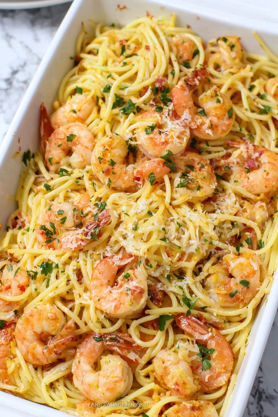 A white rectangular dish filled with long, yellow spaghetti noodles mixed with cooked orange shrimp, scattered evenly throughout the pasta. The shrimp have a slightly shiny, cooked texture with small green parsley flakes sprinkled over the top. There are some tiny white cheese shreds lightly spread across the dish, and the noodles and shrimp have a thin layer of light seasoning giving a slight shine. The background is a white marbled surface. Photo taken with an iphone --ar 2:3 --v 7 - Baked Shrimp Scampi with Pasta, shrimp scampi baked dish, quick seafood pasta recipe, easy shrimp pasta dinner, garlicky baked shrimp and pasta